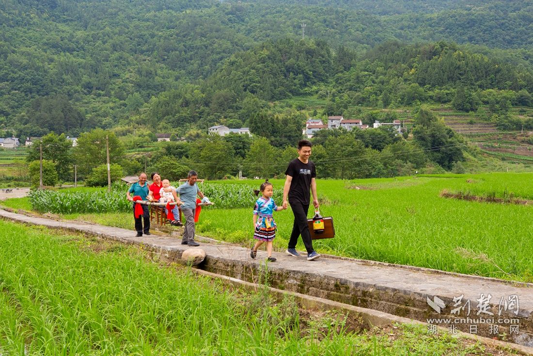 6月11日，在湖北省秭归县九畹溪镇石柱村，游客在当地体验坐滑杆、坐花轿等民俗。聂爽 摄 (2)_副本.jpg.jpg