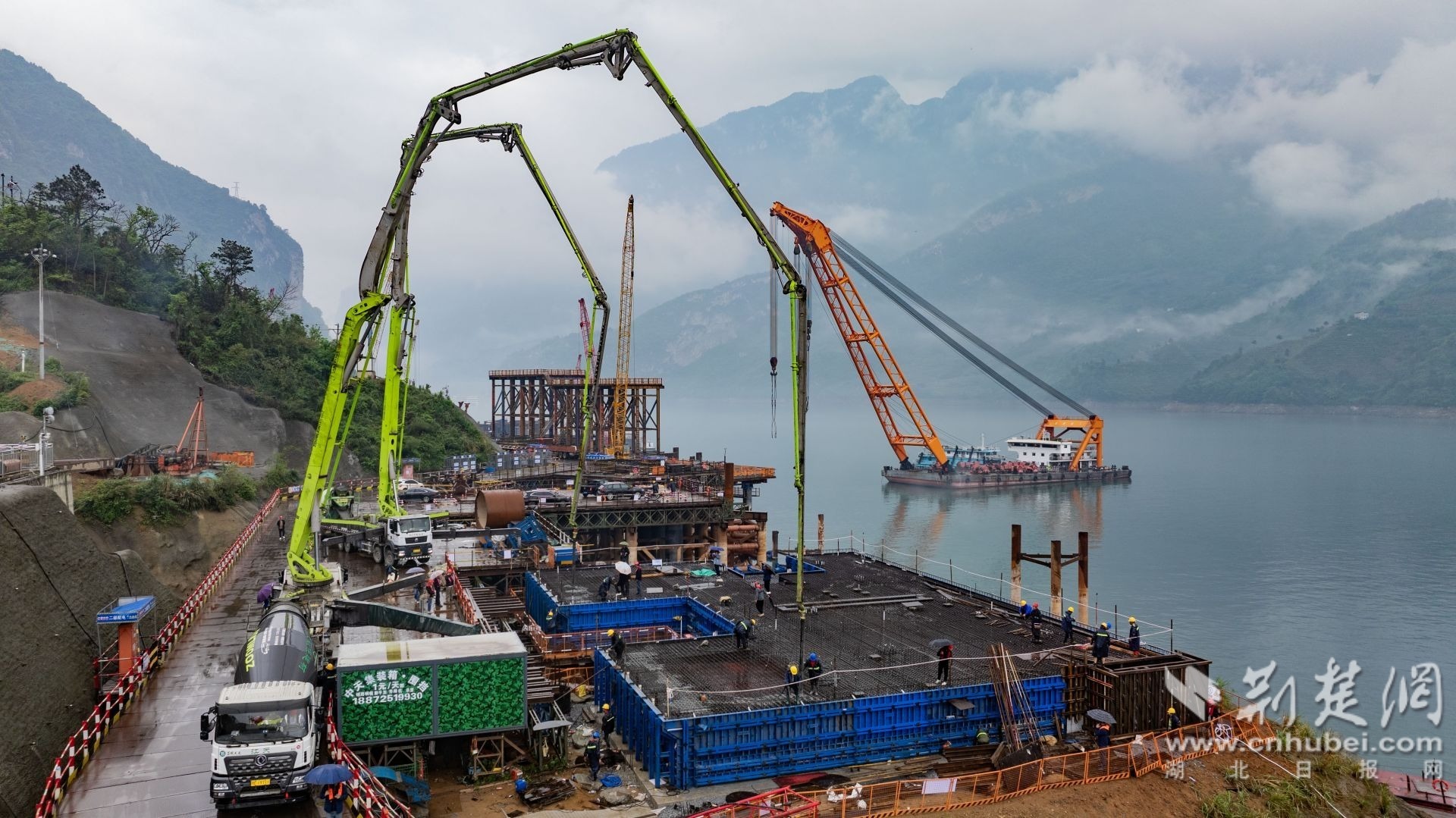 2026年4月14日，三峡库区秭归县茅坪镇三峡枢纽江南成品油翻坝项目坝上码头工程现场一片火热，工人们正加紧进行墩台浇筑施工作业。